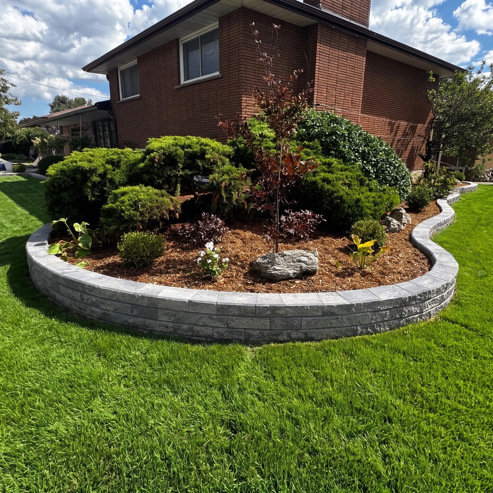 Curved garden retaining wall and landscape